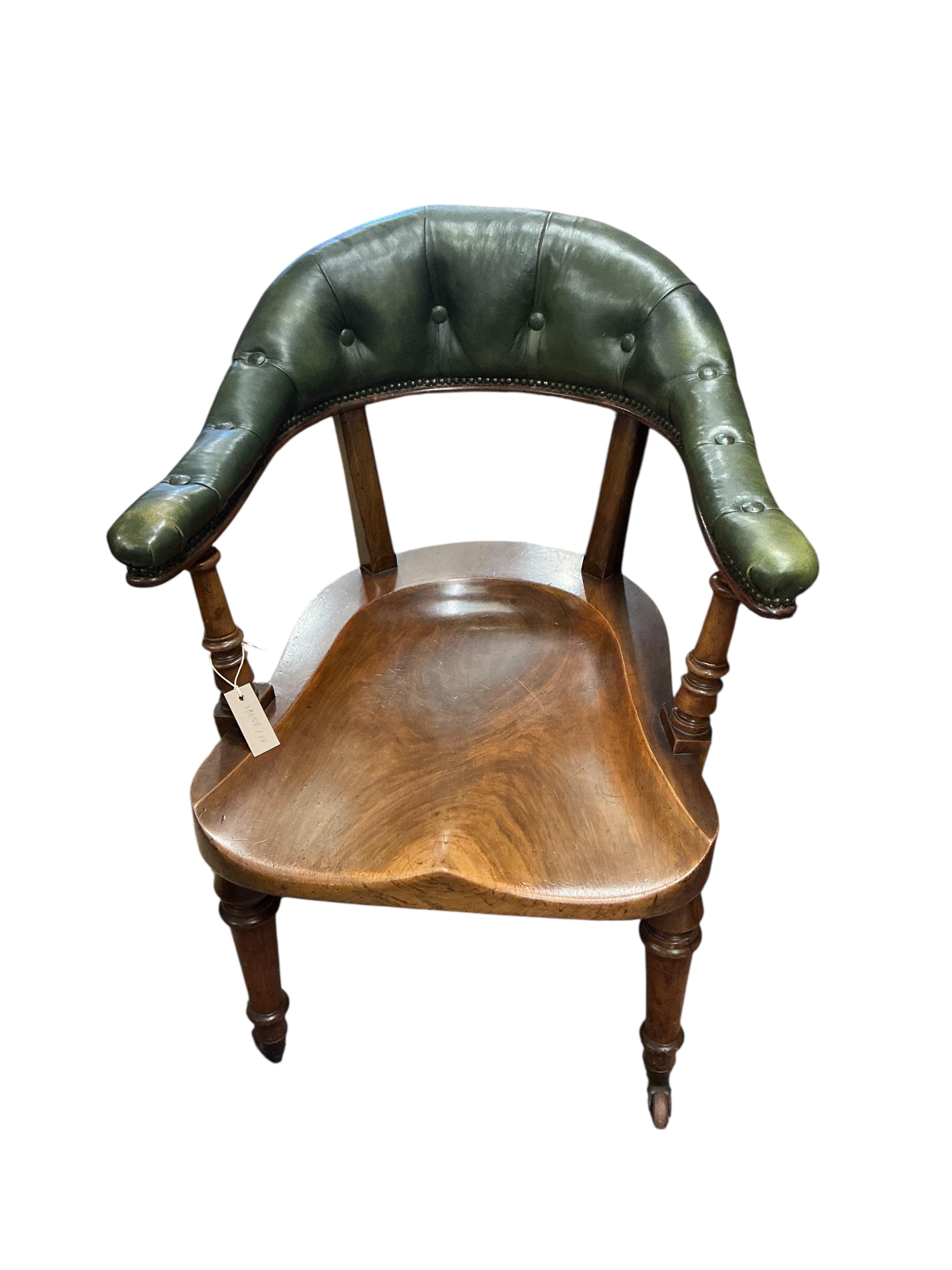 A Victorian mahogany and green buttoned leather desk chair, width 62cm, depth 60cm, height 85cm